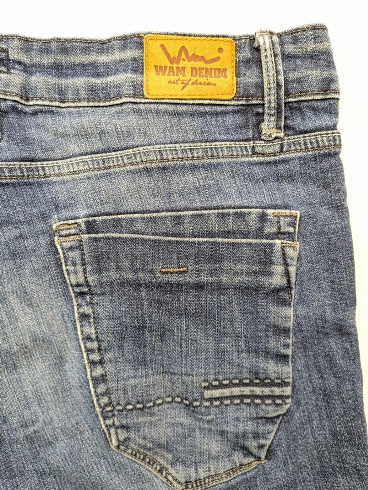 WAM Denim blue straight jeans with distressed details and button fly.