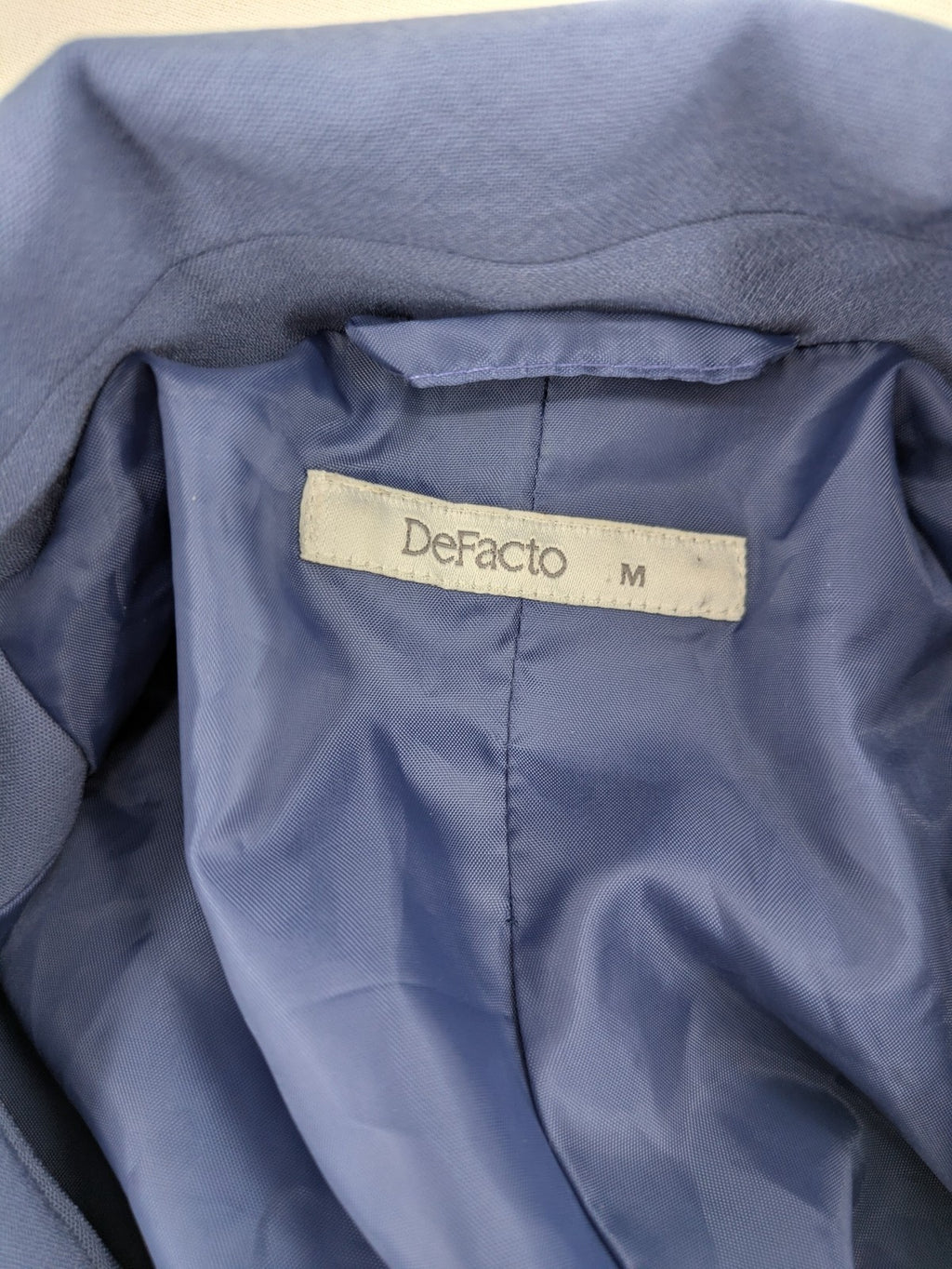 DeFacto blue trench coat with classic lapels and matching self-tie belt.