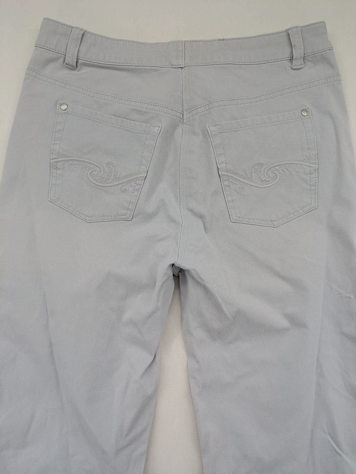 Chino grey capri pants five-pocket design with subtle embroidery and stretch cotton blend.