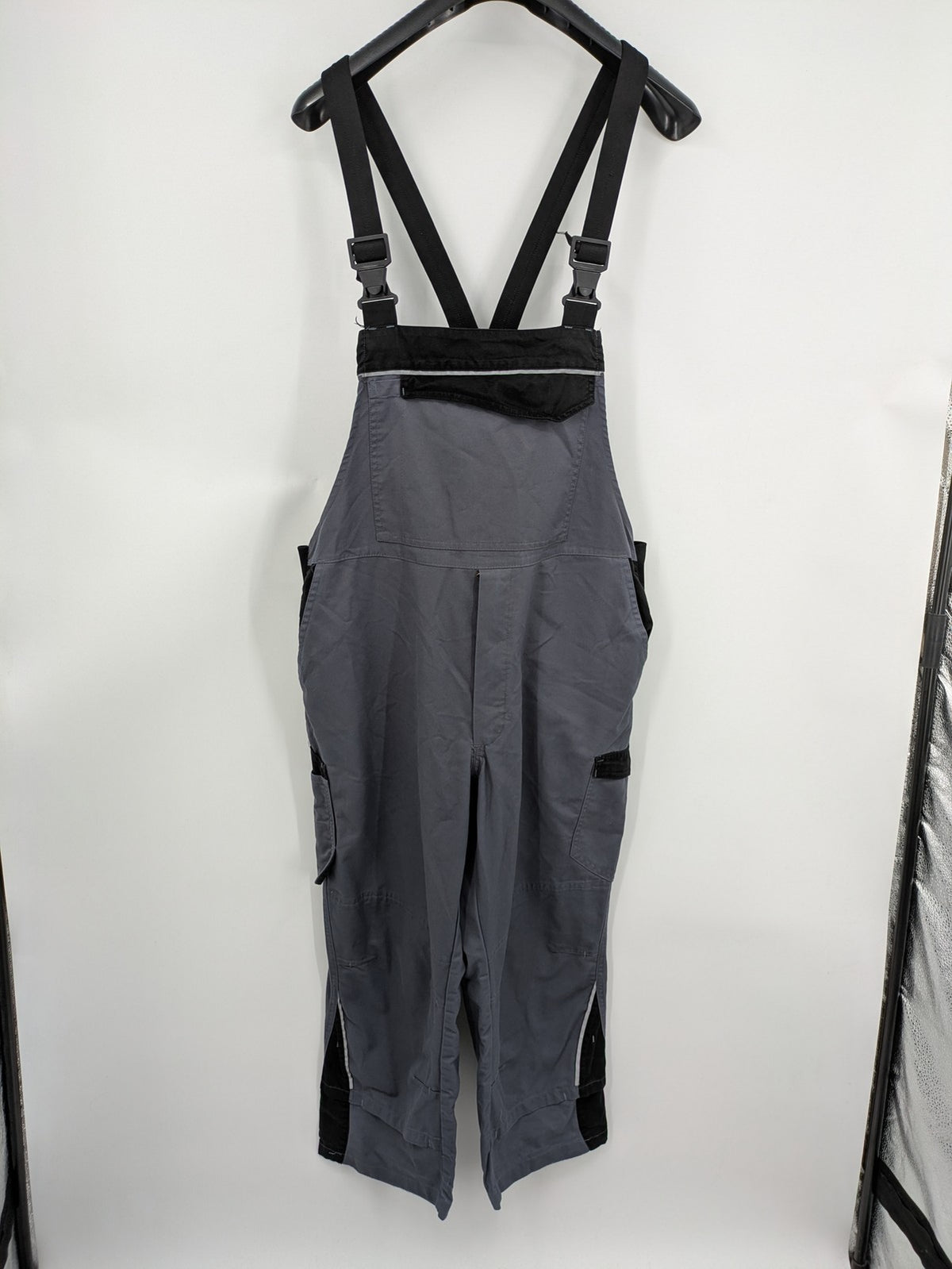 Works Wear grey and black overalls with adjustable straps and multiple pockets.