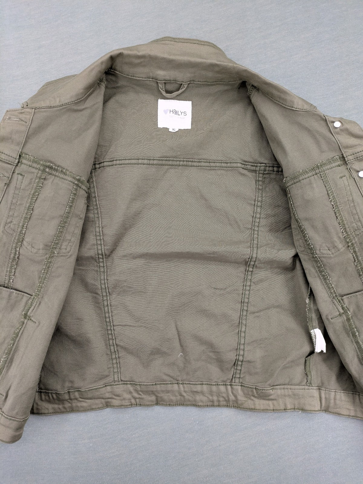 Hailys khaki denim jacket with button closure, two chest pockets, and side pockets.