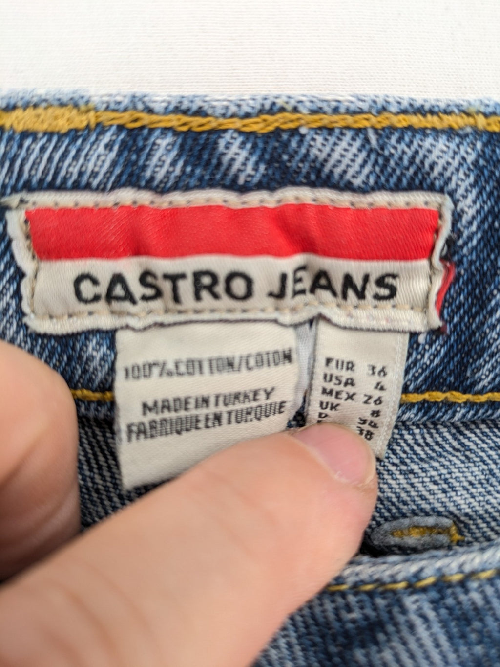Castro Jeans blue straight leg jeans high waist with white paint splatter details.