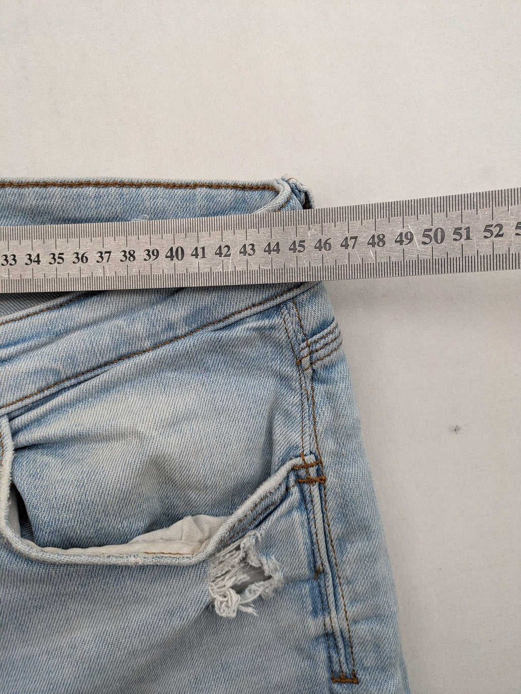 Zara blue straight jeans with distressed knees and classic button fly.