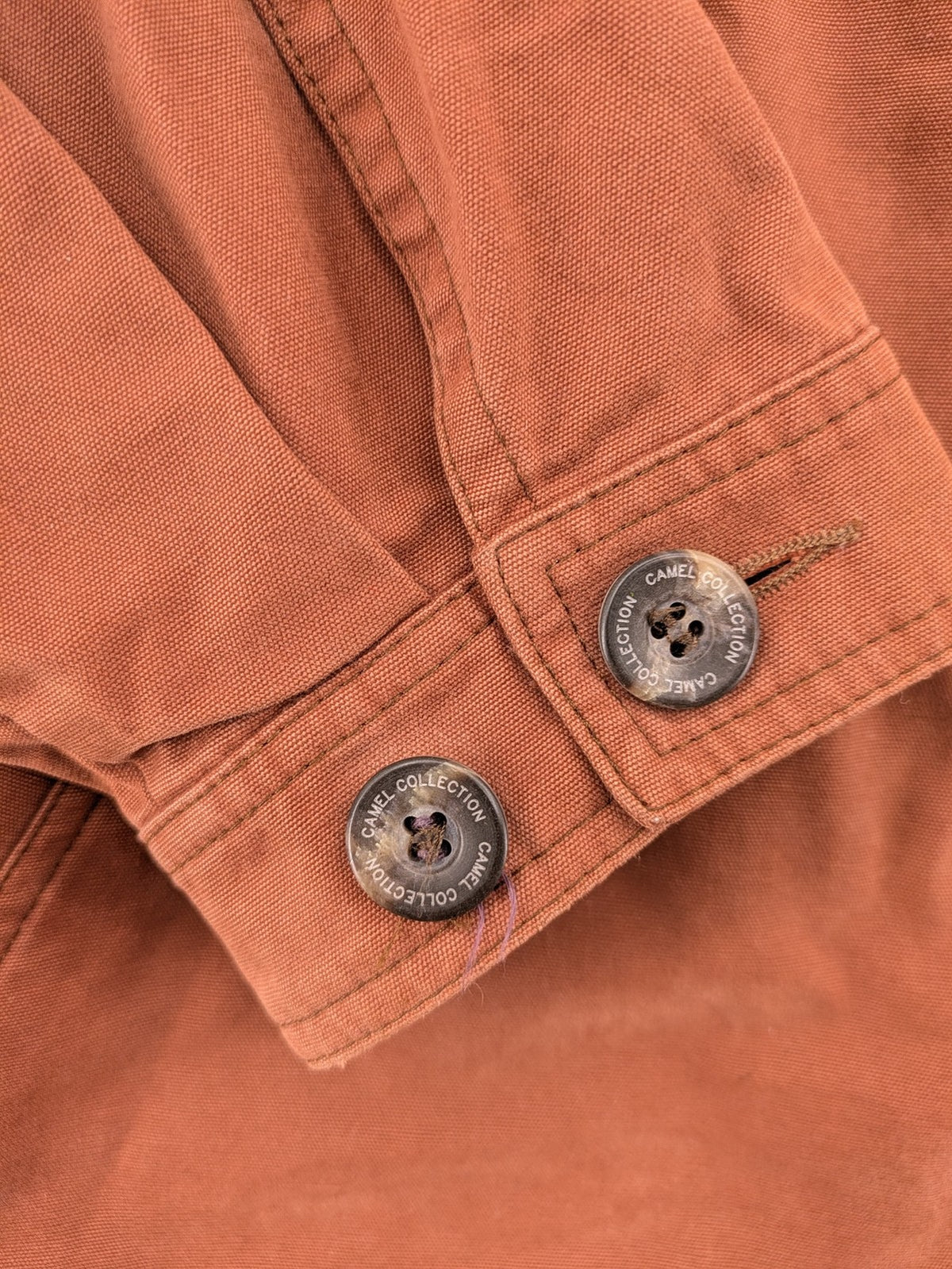 Camel Collection brown jacket with orange contrast collar and embroidered logo.
