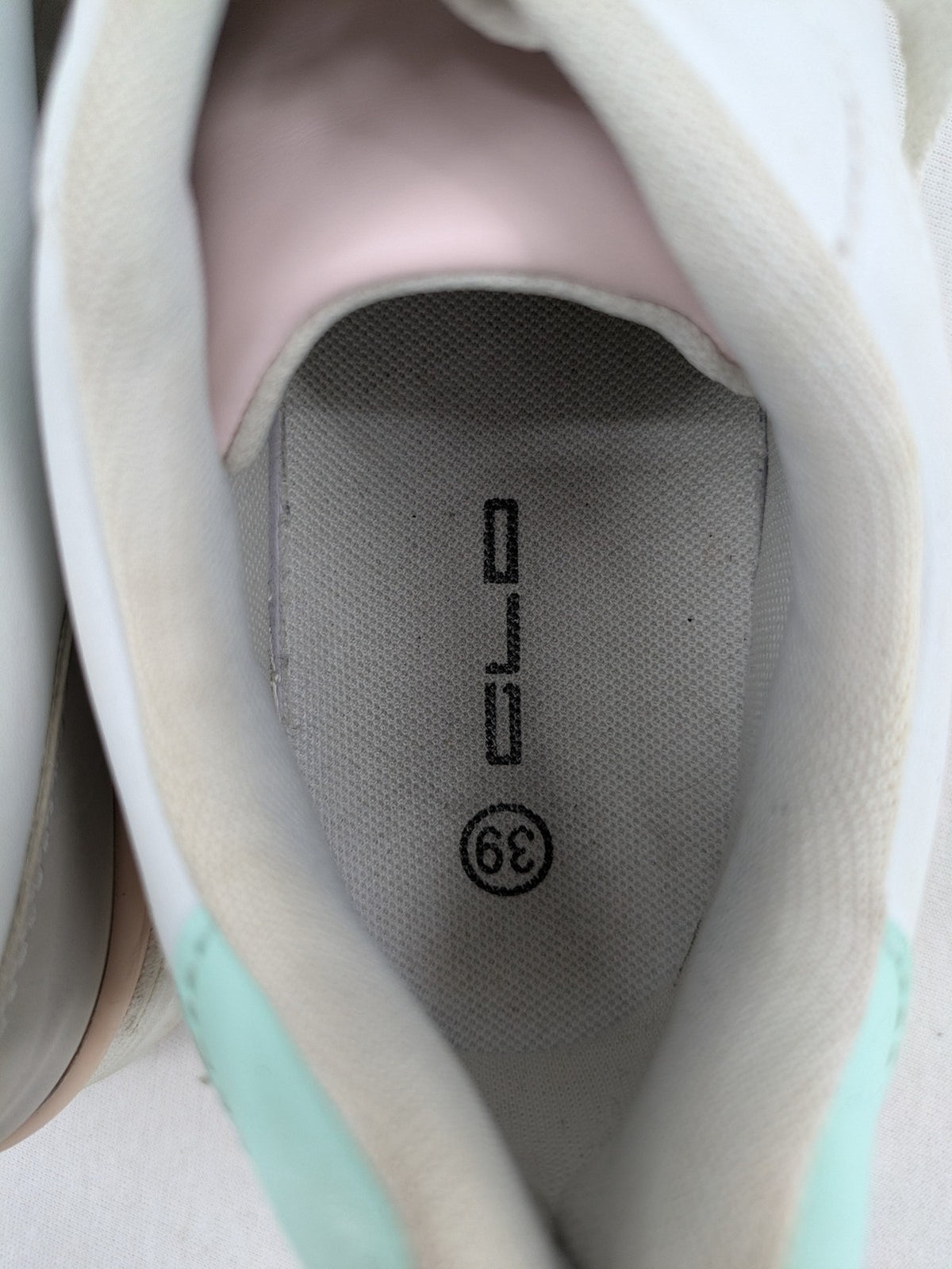 Graceland white sneakers with pink and mint green accents, low-top design, cushioned tongue.
