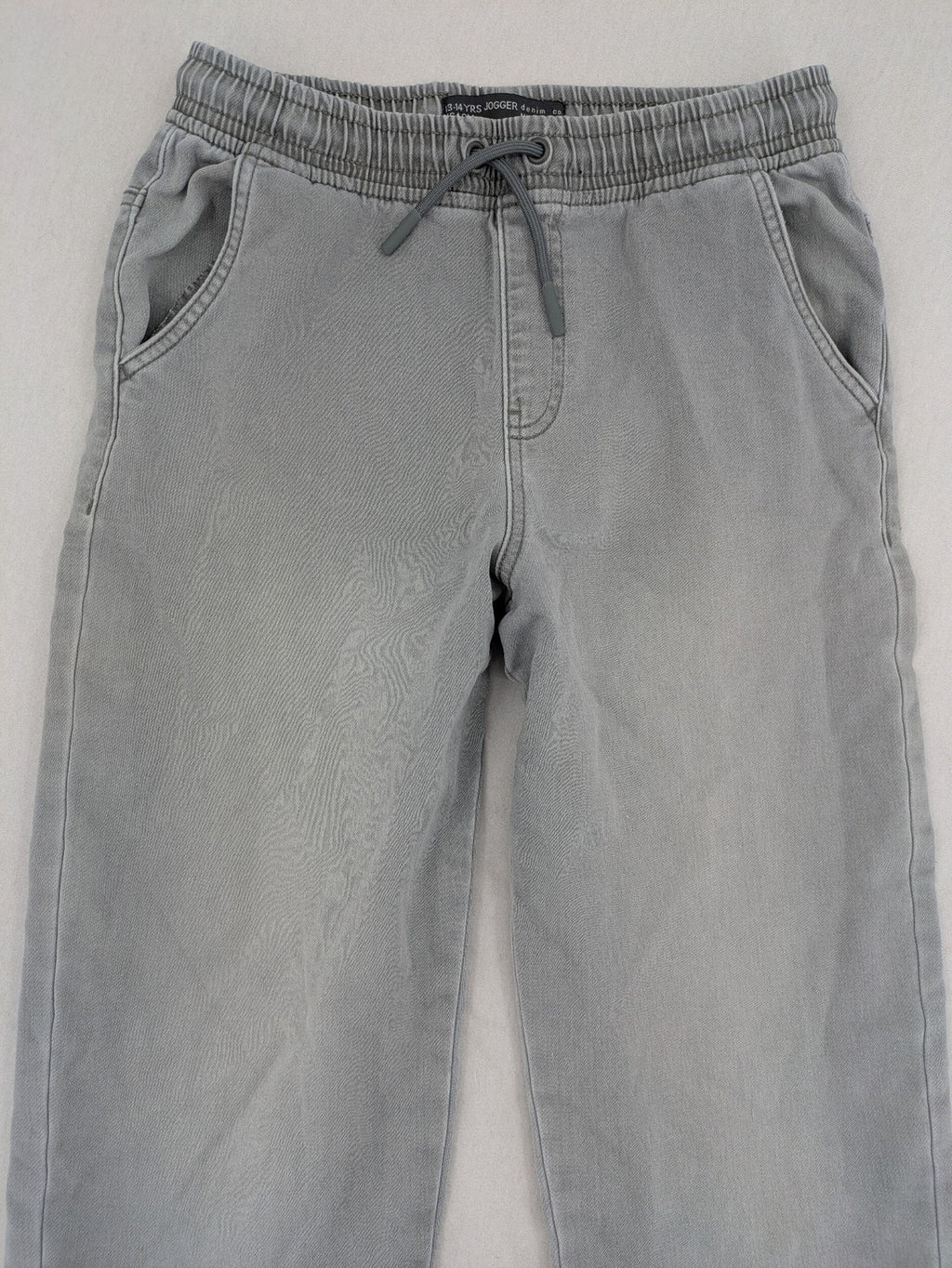 Denim & Co. grey jogger jeans with elastic waistband and ankle cuffs, cotton material.