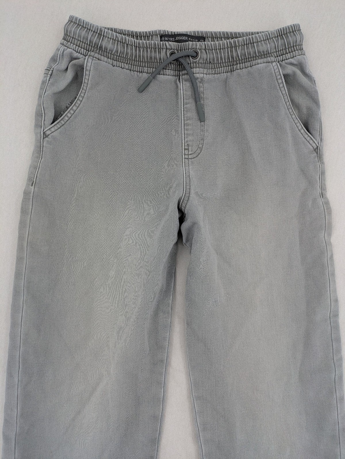 Denim & Co. grey jogger jeans with elastic waistband and ankle cuffs, cotton material.