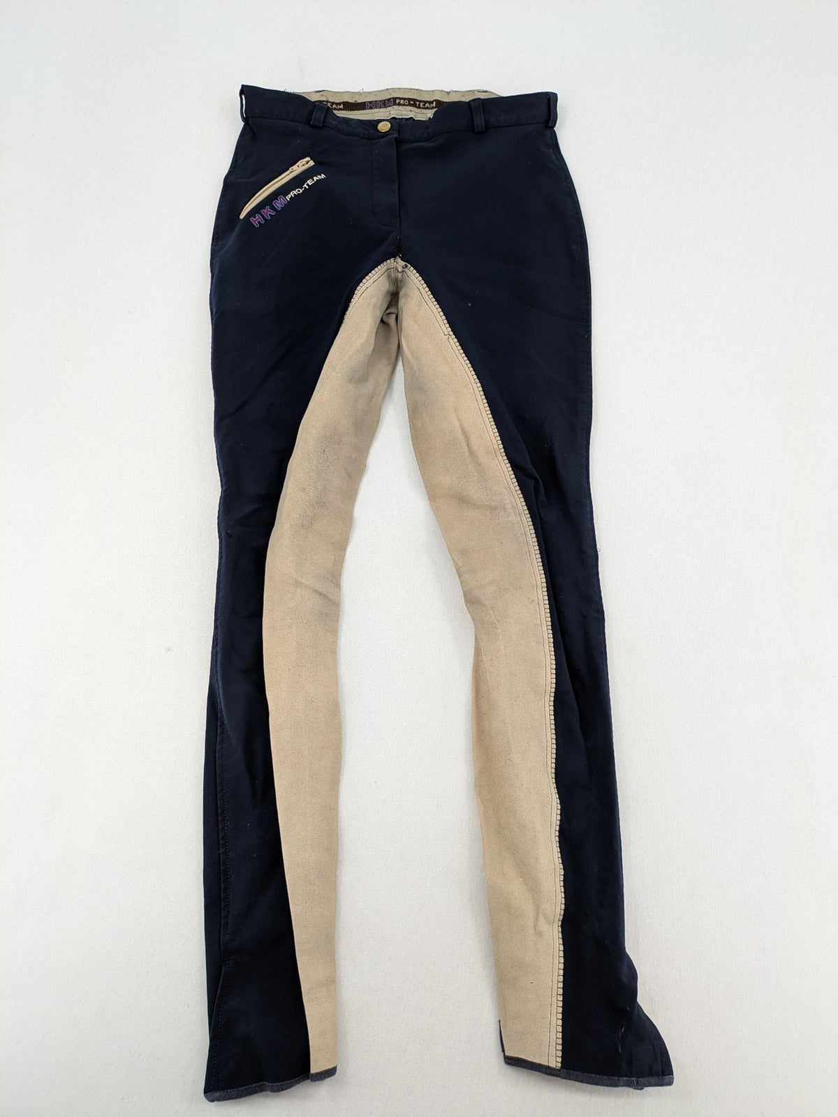 H&KM beige riding pants with dark blue full seat and front zippers.