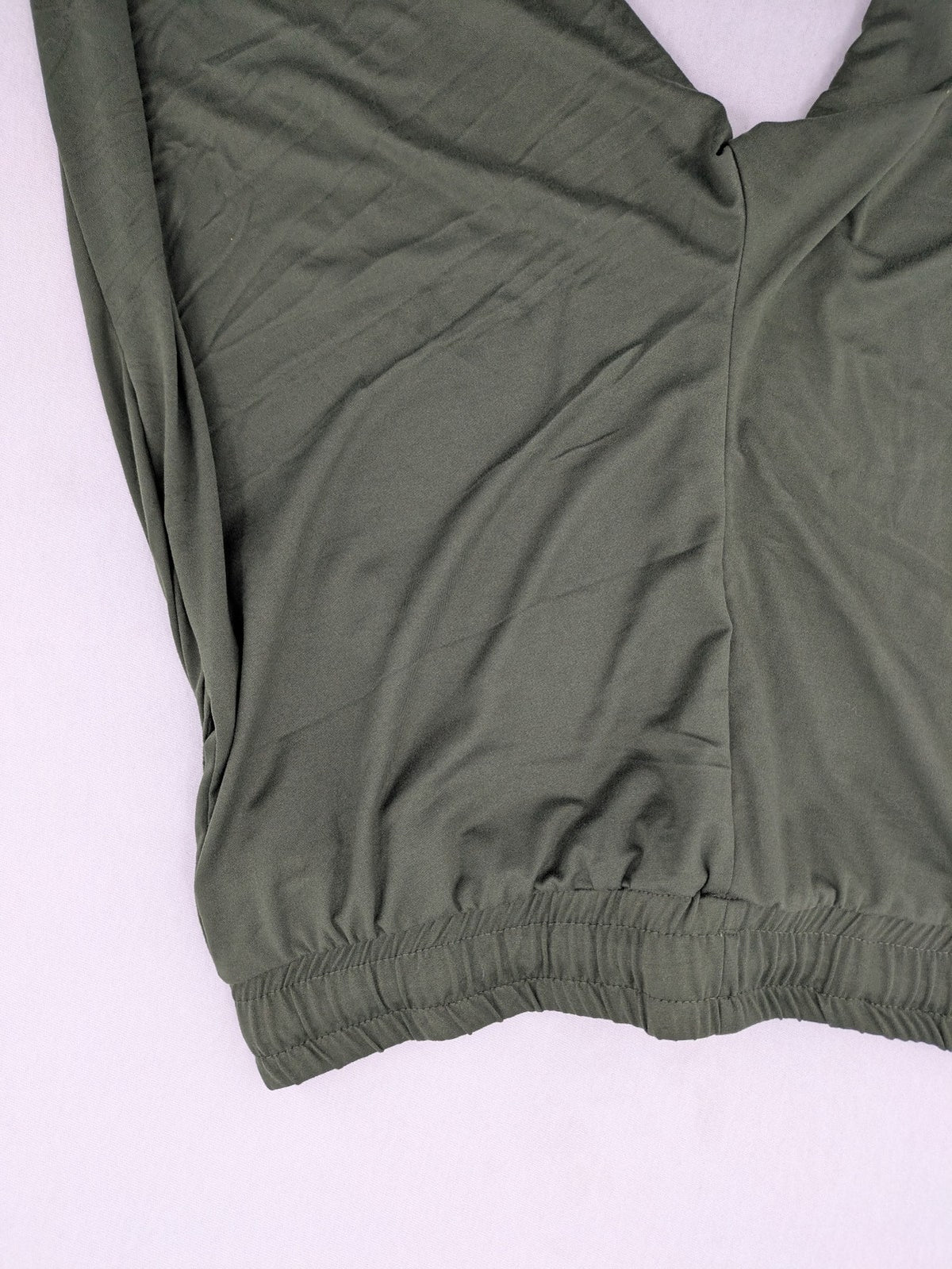 Infinity green jogger pants with elastic waistband and side pockets, soft stretch material.