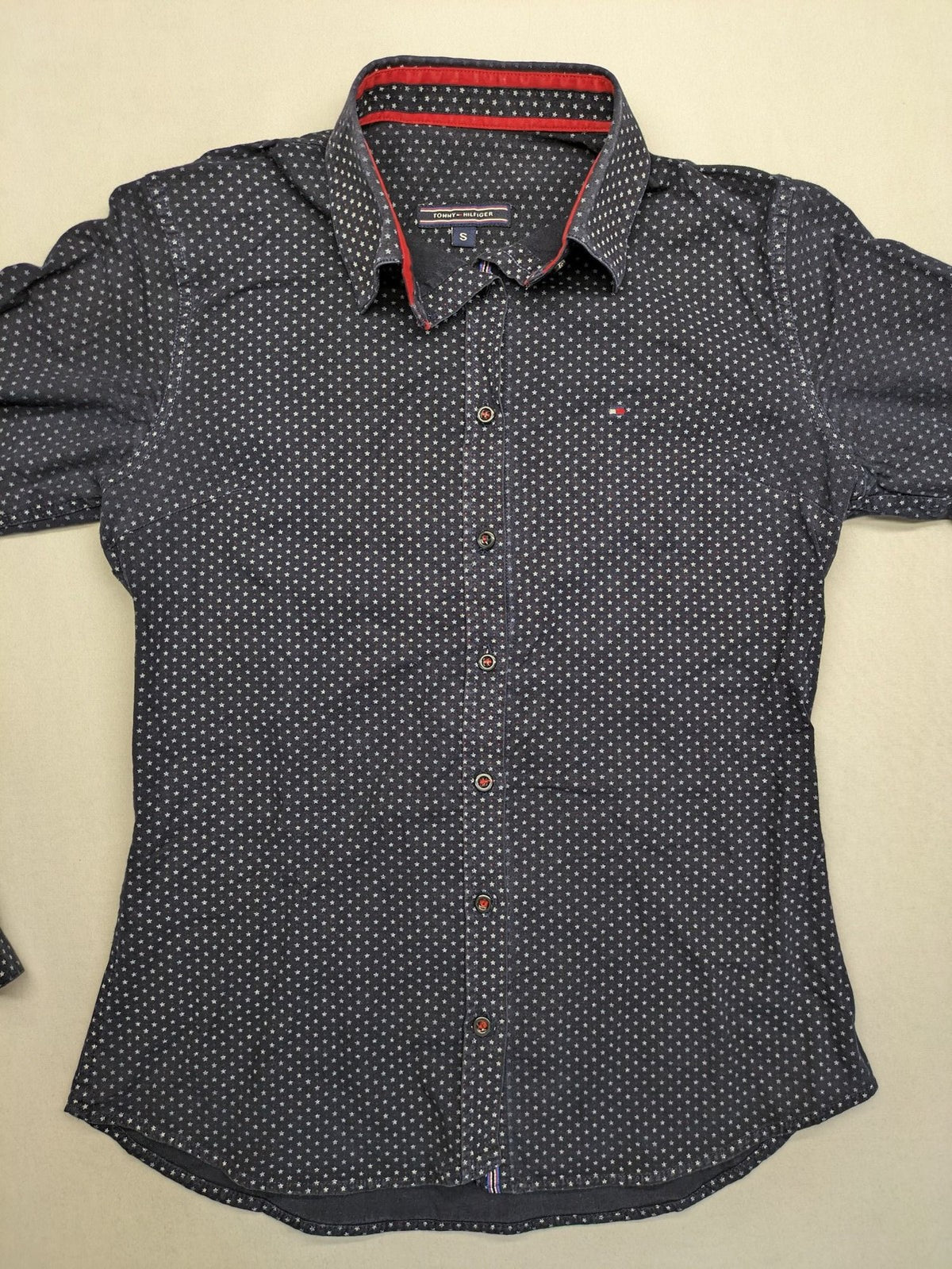 Tommy Hilfiger navy button-down shirt with white star pattern and embroidered flag logo.