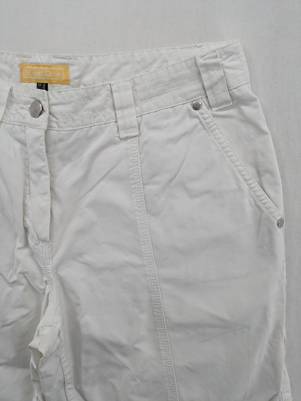Street One white cargo pants with side pockets and wide leg design.
