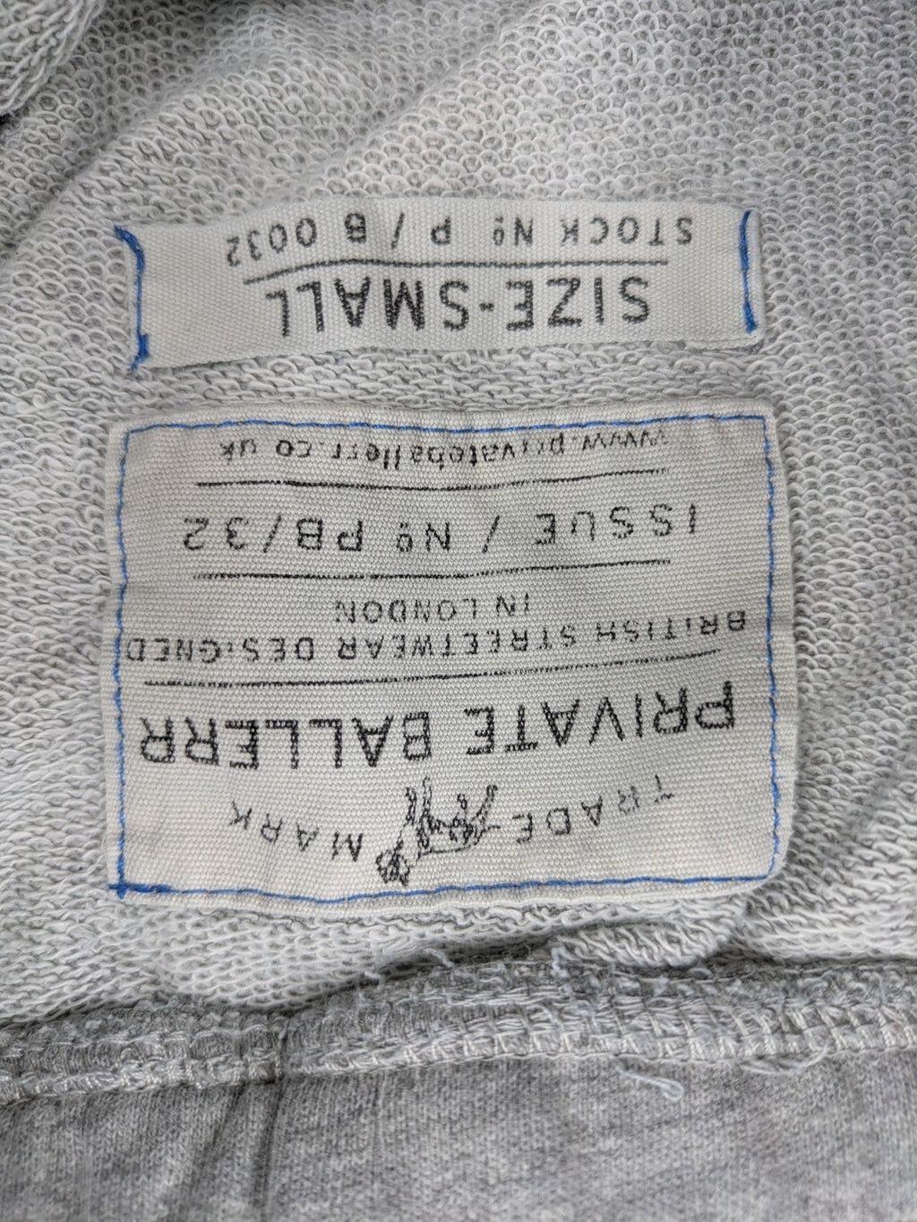 Private Baller grey sweatpants with "32" graphic print and blue drawstring.