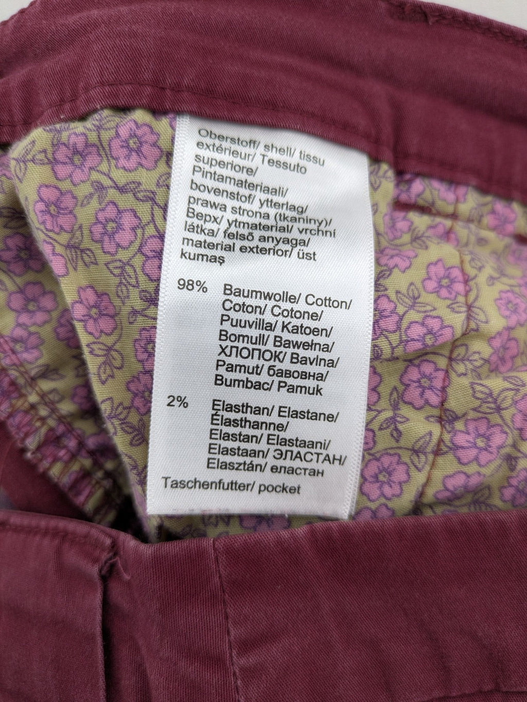BPC Bonprix burgundy chino pants with front pleats and floral pocket lining.