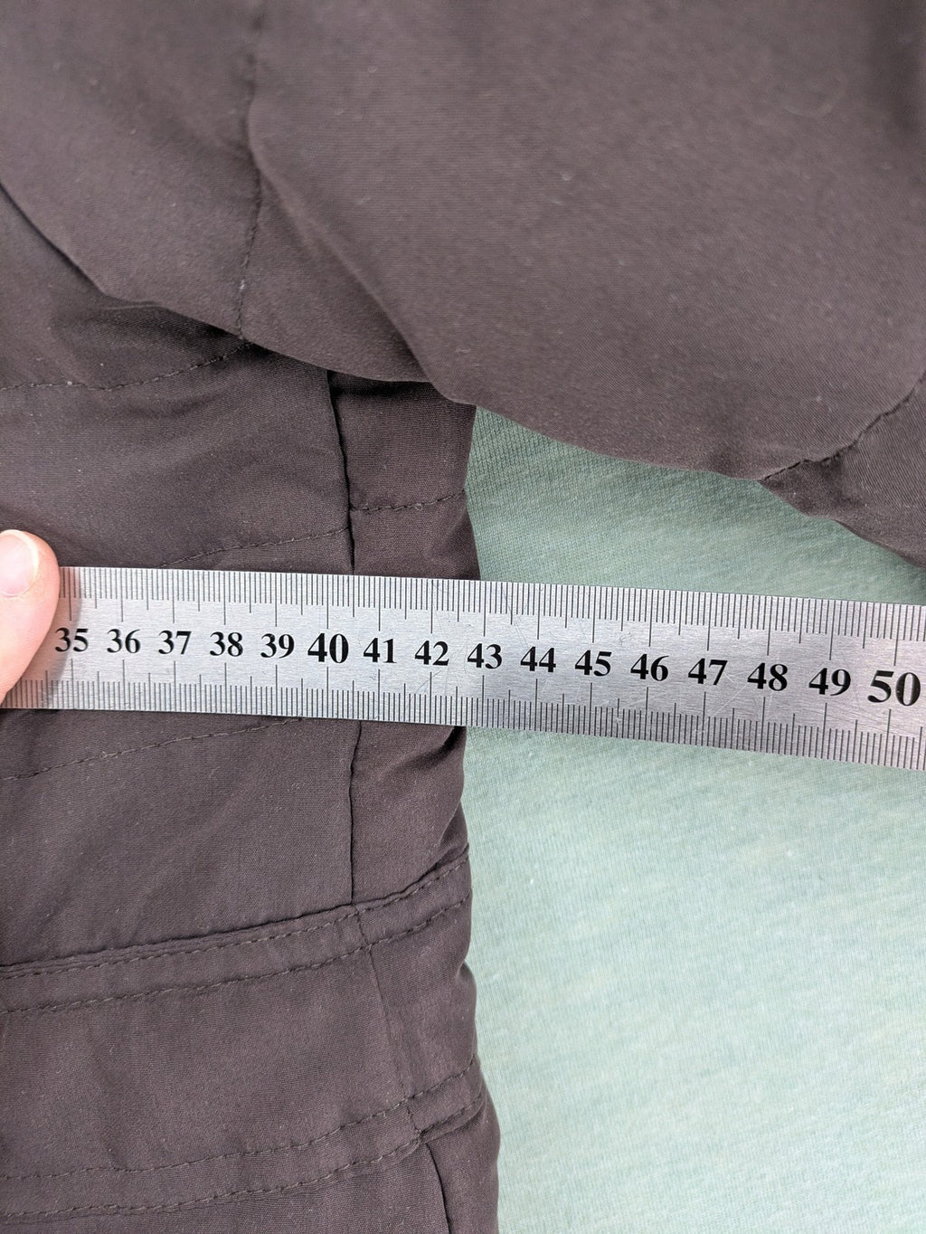 Vero Moda grey quilted jacket with high funnel neck and zippered pockets.