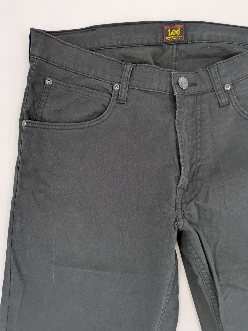 Lee straight jeans grey classic 5-pocket design with zip fly and subtle branding.