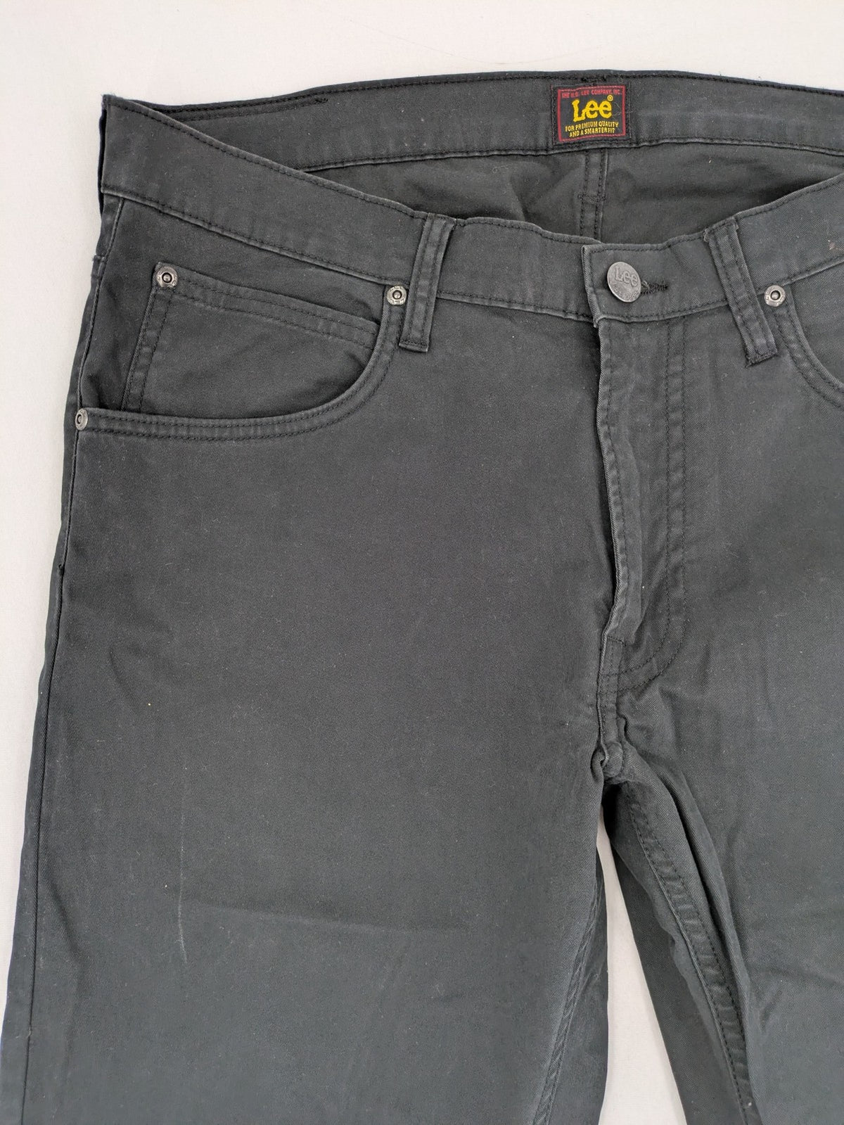 Lee straight jeans grey classic 5-pocket design with zip fly and subtle branding.