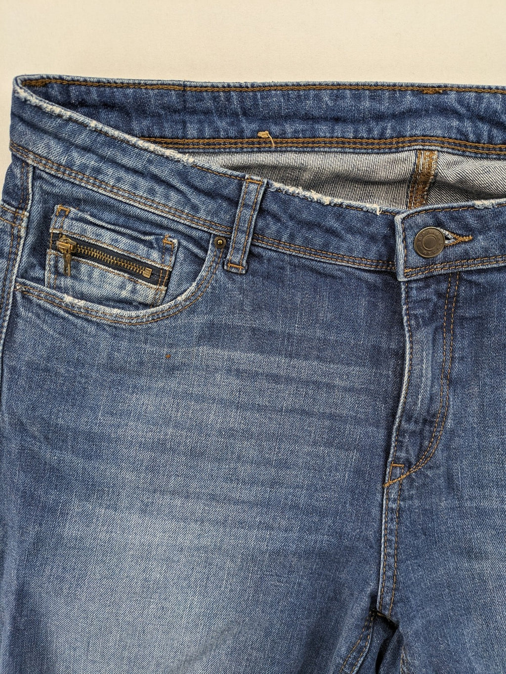 Esprit blue straight leg jeans with ripped knee details and rolled hem.