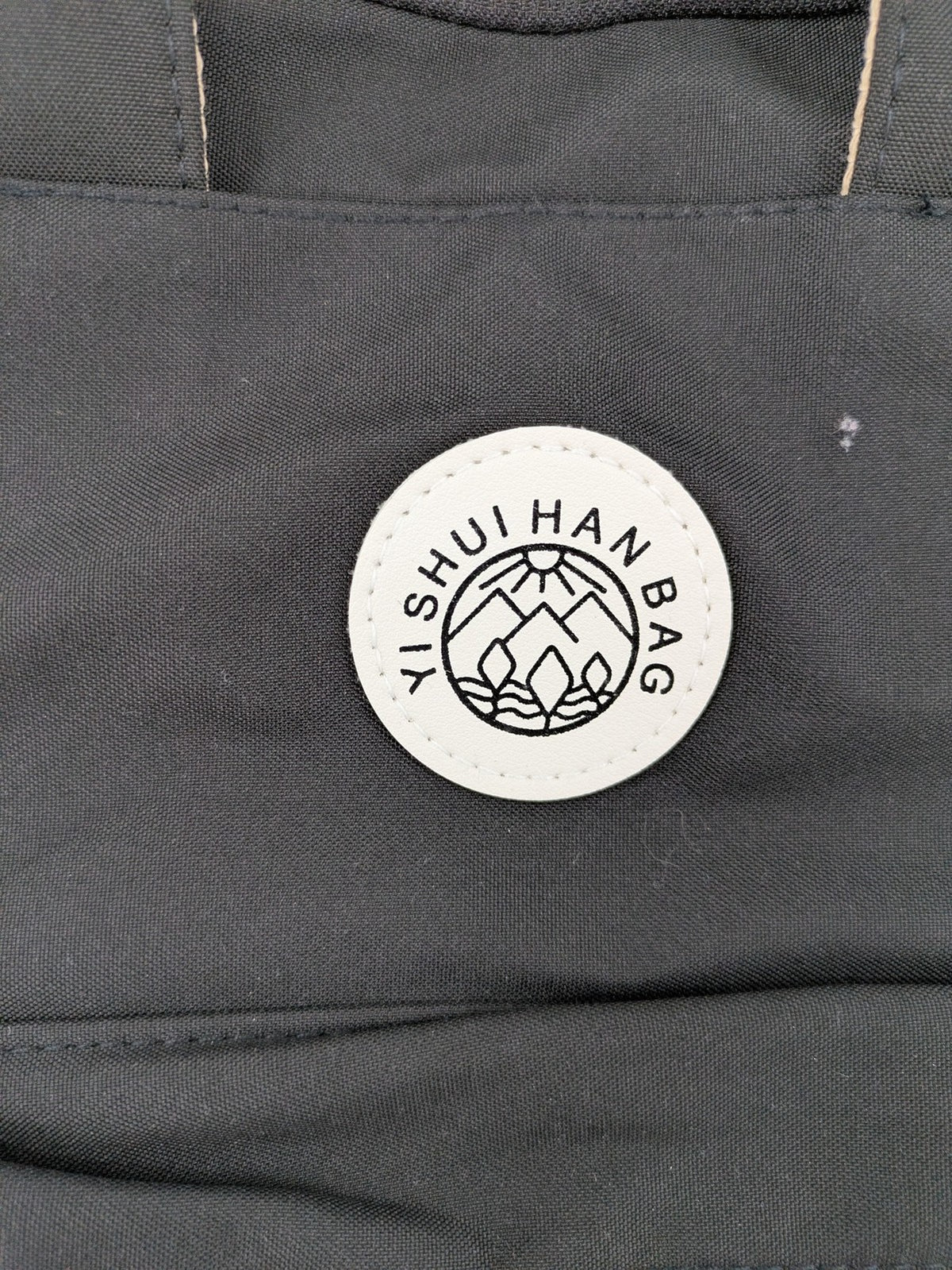 Yishuihan grey messenger bag with multiple pockets and contrast detailing.