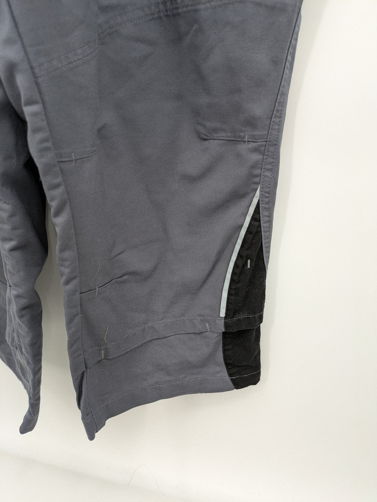 Works Wear grey and black overalls with adjustable straps and multiple pockets.