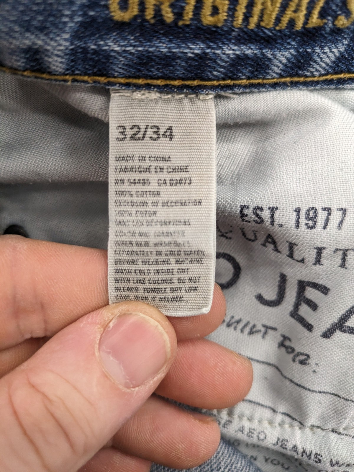 American Eagle Outfitters blue straight jeans with distressed detailing and classic five-pocket design.