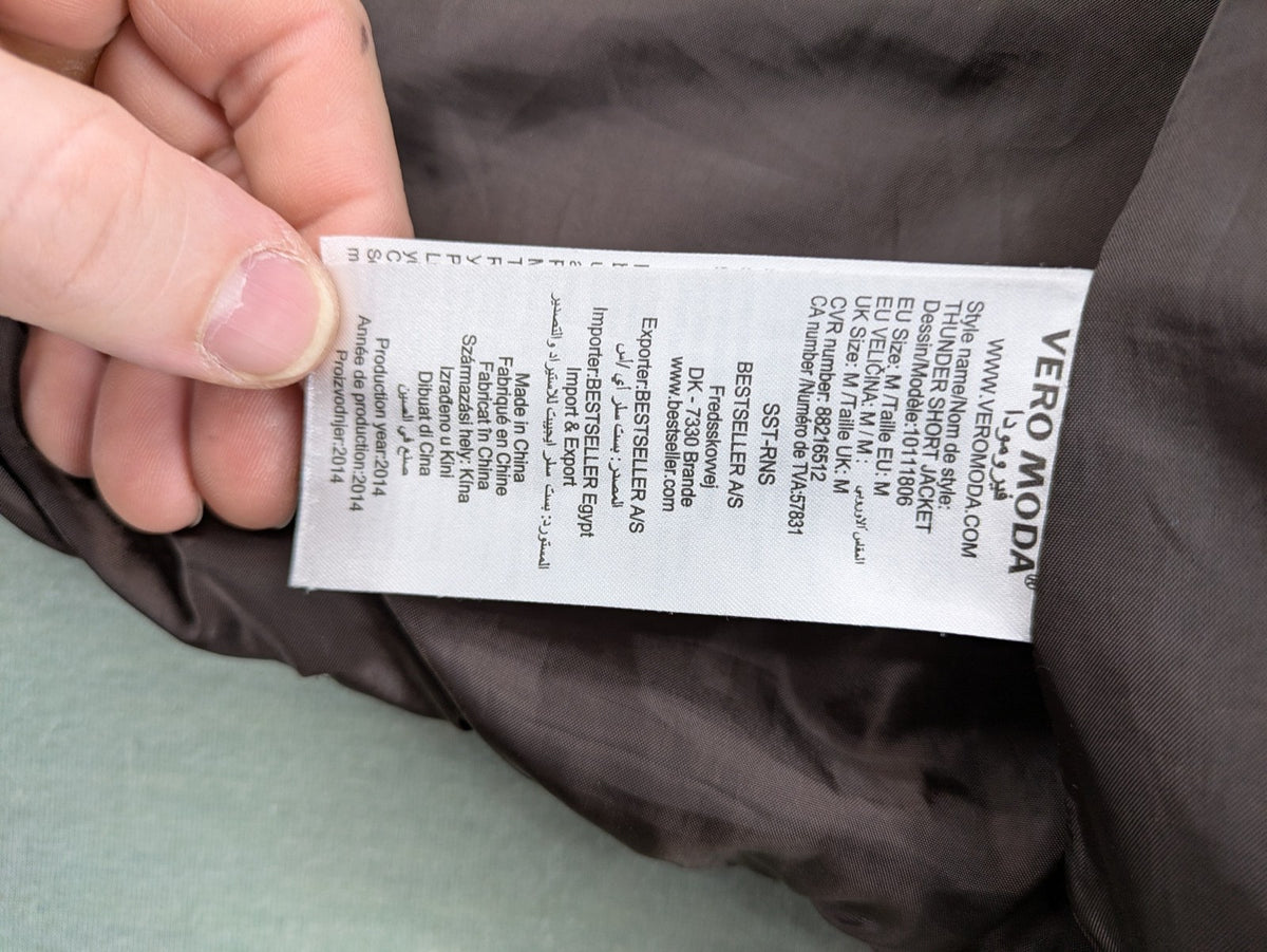 Vero Moda grey quilted jacket with high funnel neck and zippered pockets.