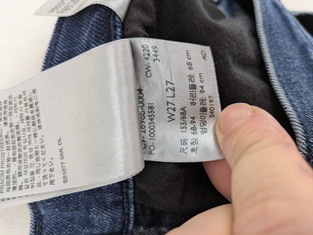 Levi's high waisted taper jeans dark blue 5-pocket design with zipper and stretch material.