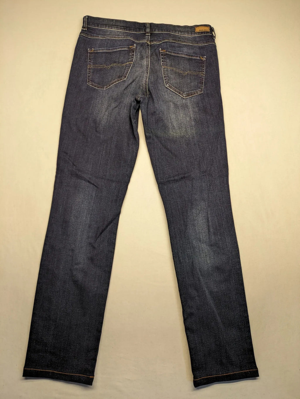 Diesel blue straight jeans with regular waist, dark wash, and stretch material.