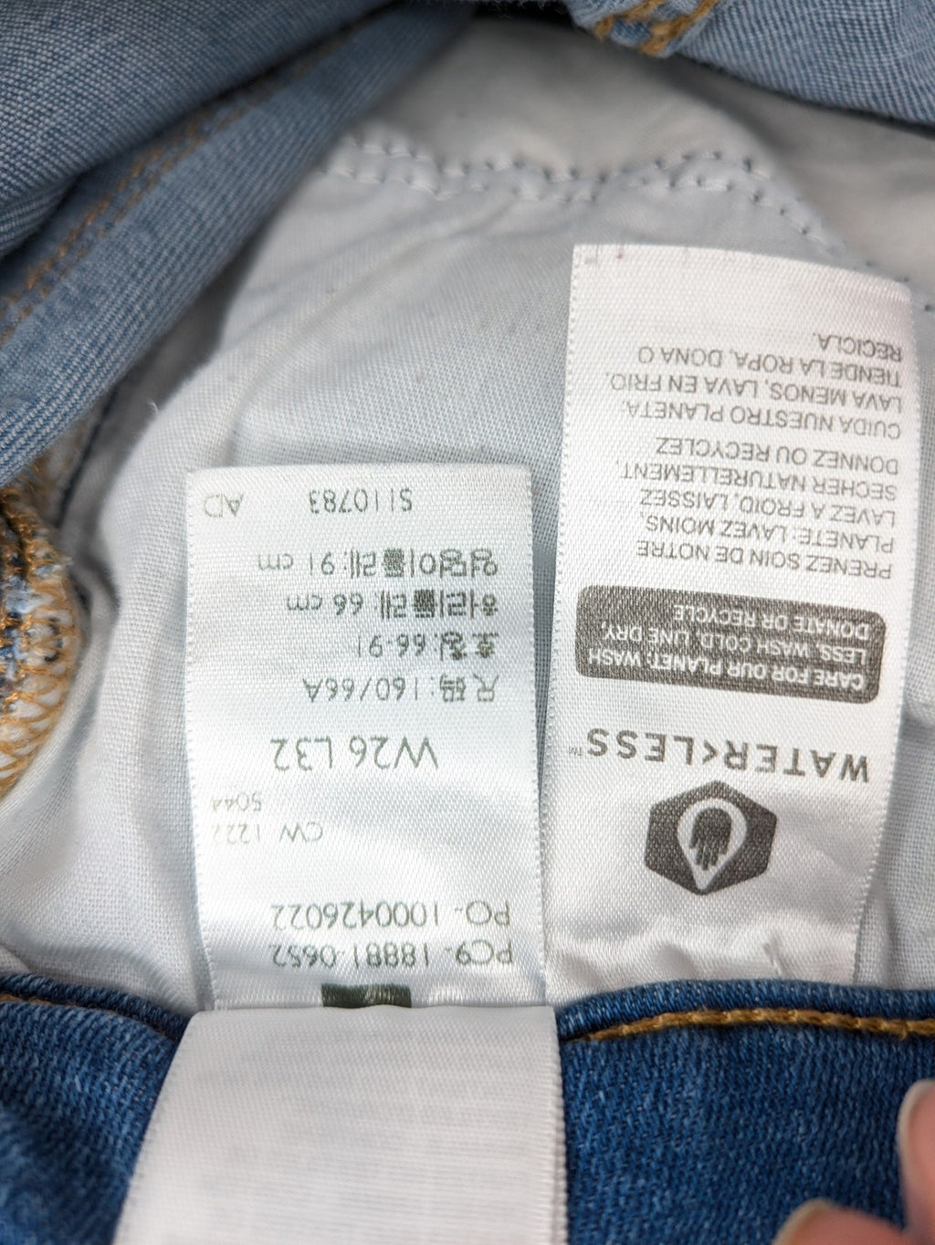 Levi's blue skinny jeans with raw hem, classic five-pocket design, and zip fly.