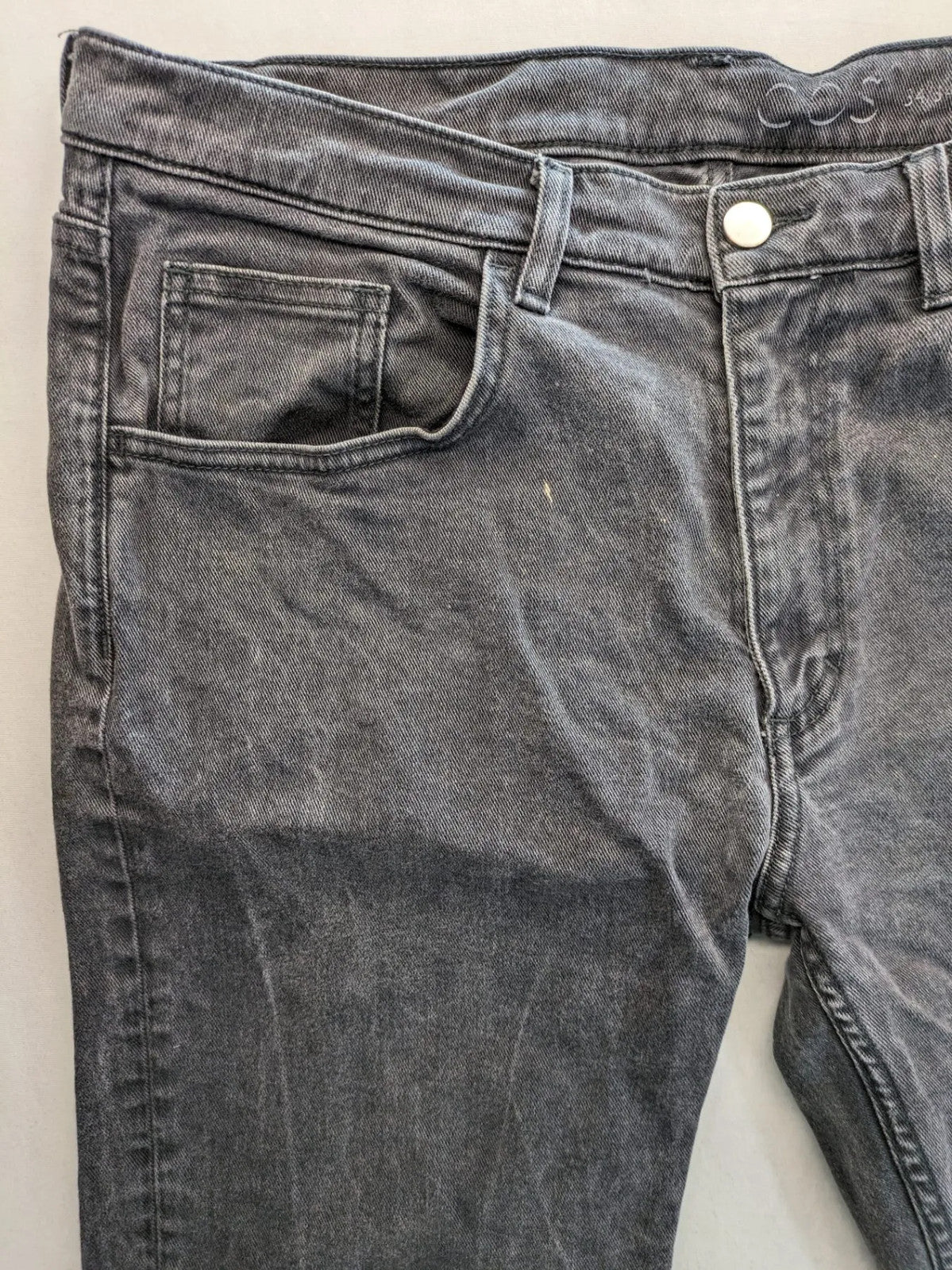 COS grey straight jeans with classic 5-pocket style and washed denim texture.