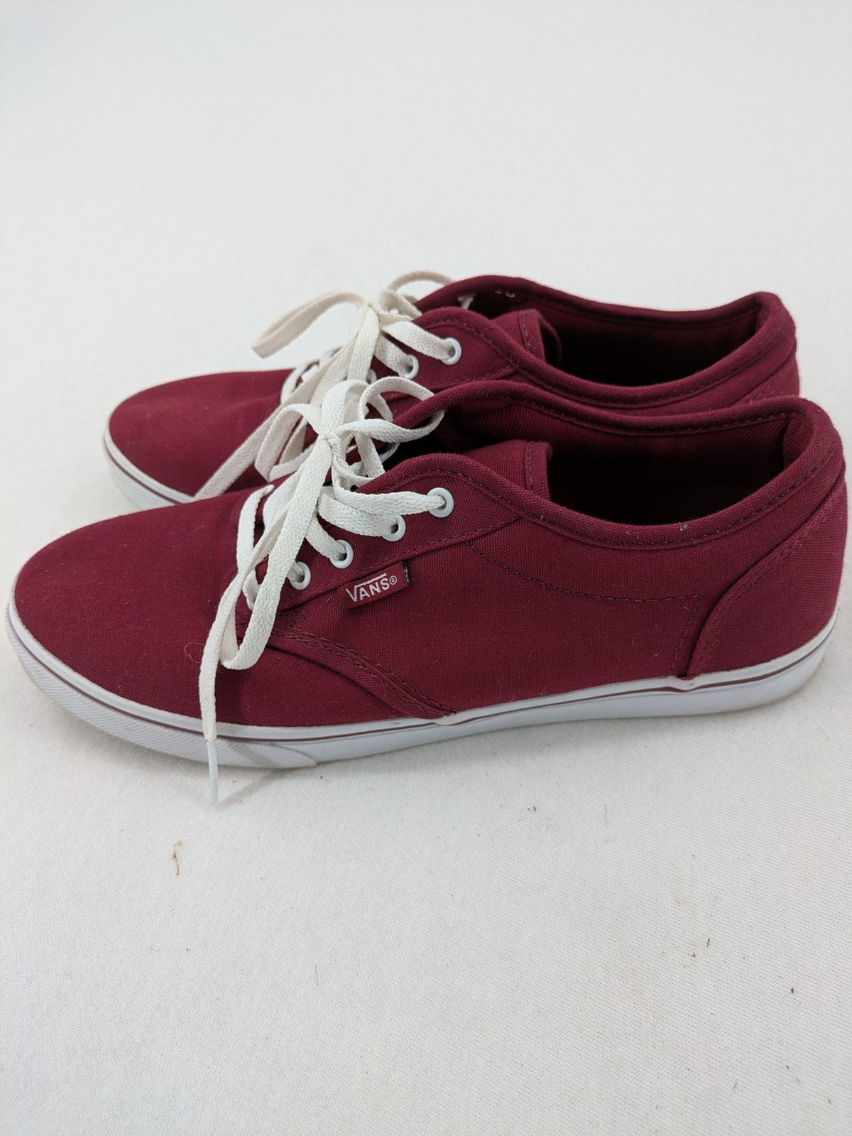 Vans low-top sneakers burgundy canvas with white logo and classic waffle sole.