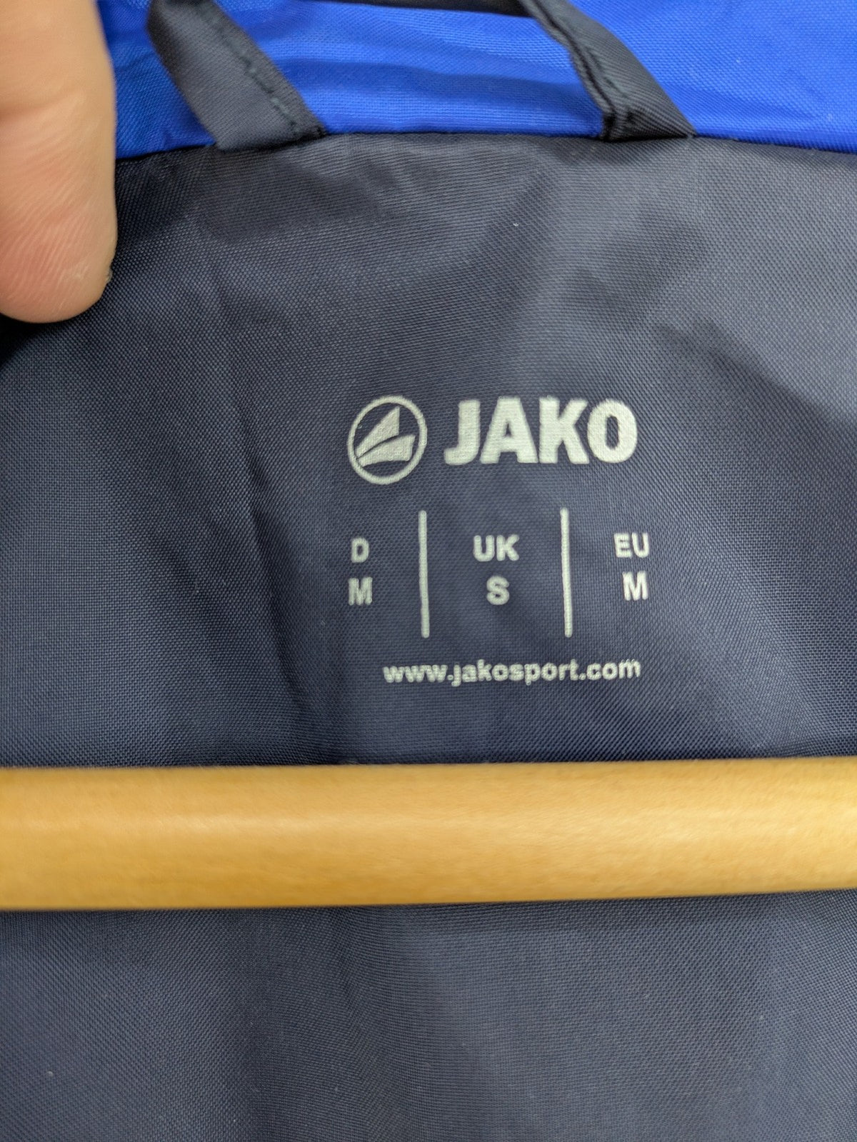 Jako navy windbreaker full zip jacket with breathable mesh lining and logo details.