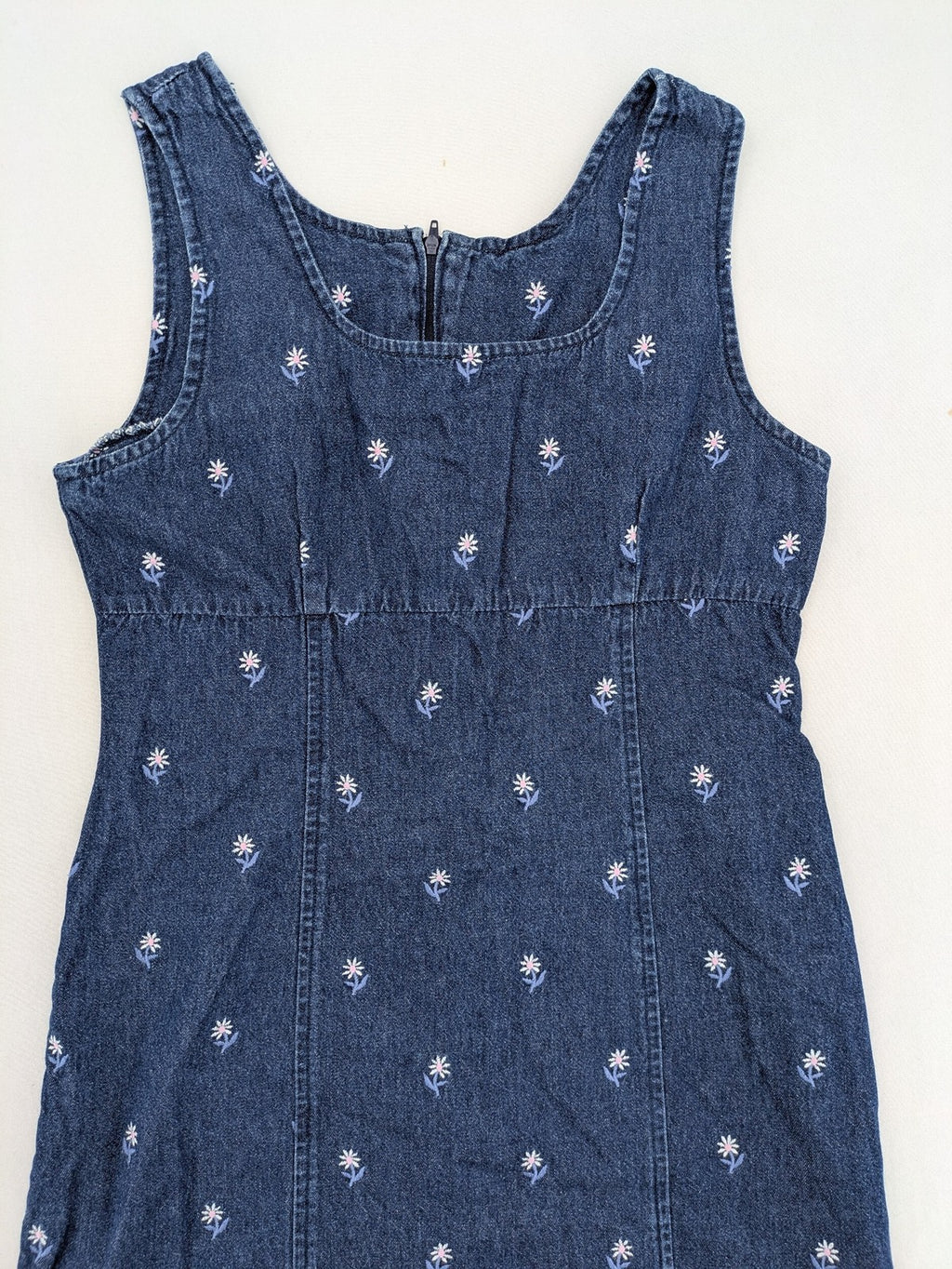 Damen blue denim mini dress with all-over white and light blue floral embroidery.