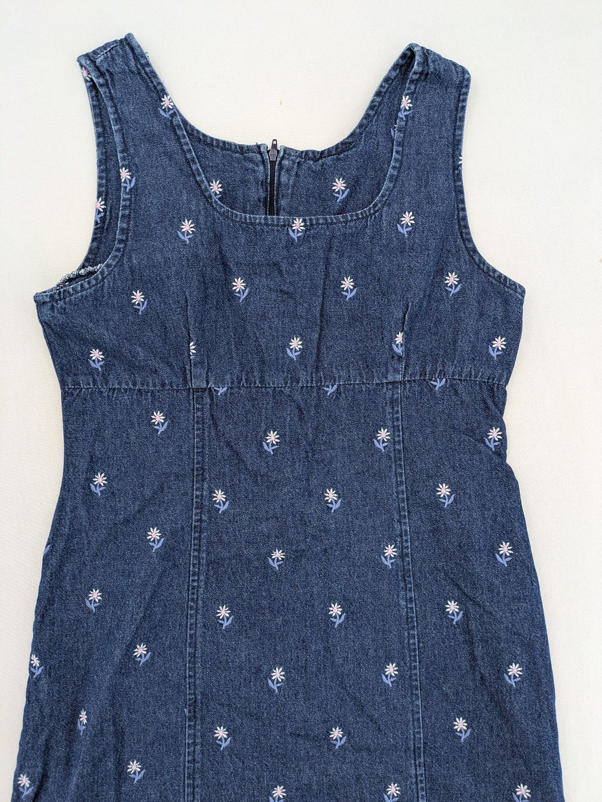 Damen blue denim mini dress with all-over white and light blue floral embroidery.
