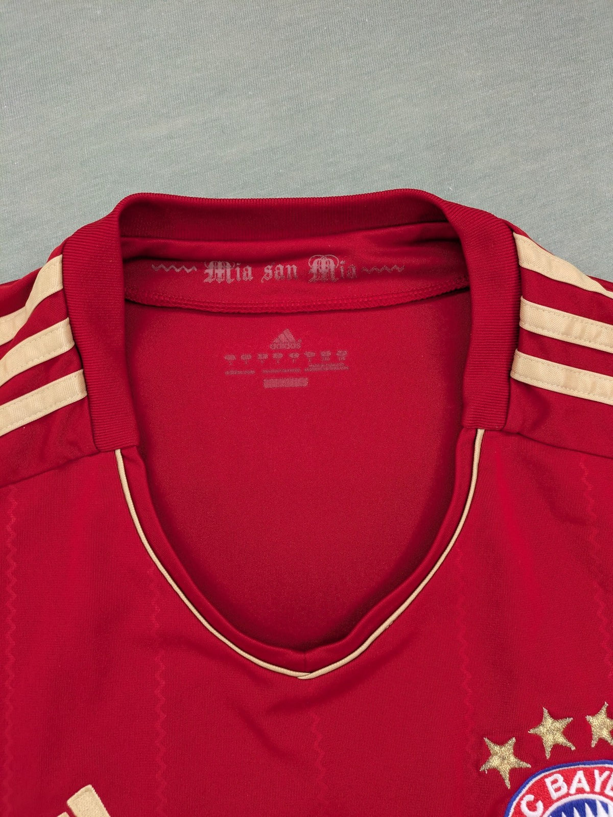Adidas red soccer uniform with embroidered FC Bayern München crest and T-Mobile logo.