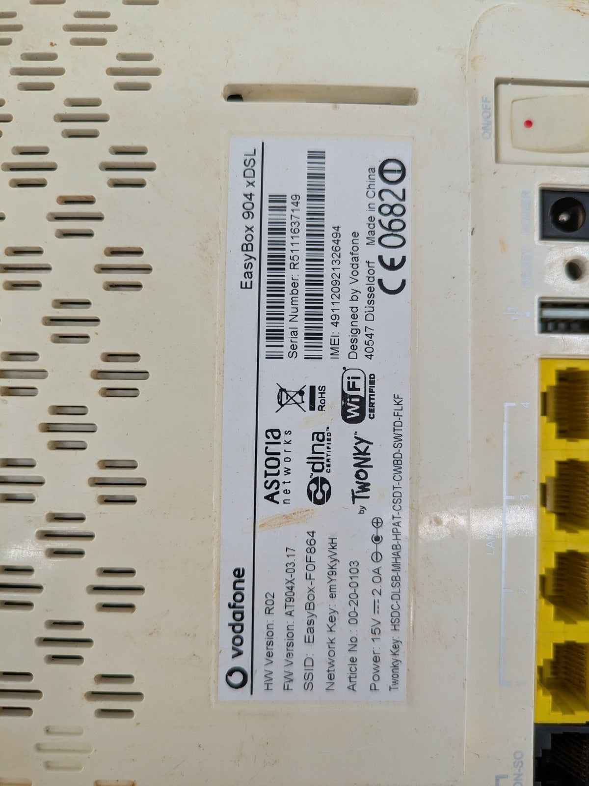Vodafone wireless router beige and black with multiple LAN ports and USB connection.
