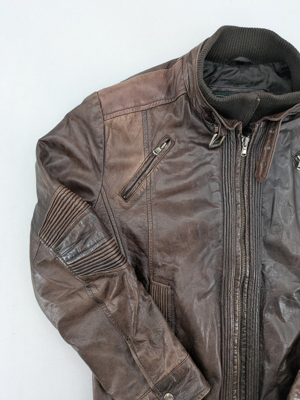 H&M green leather bomber jacket with ribbed collar and moto-style padding.