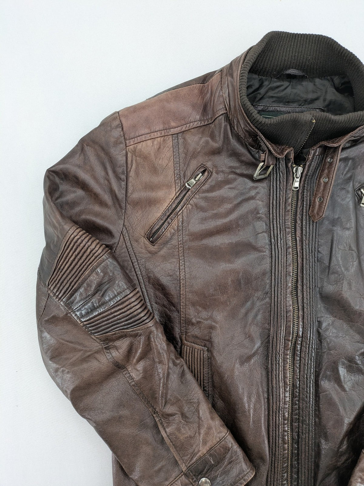 H&M green leather bomber jacket with ribbed collar and moto-style padding.