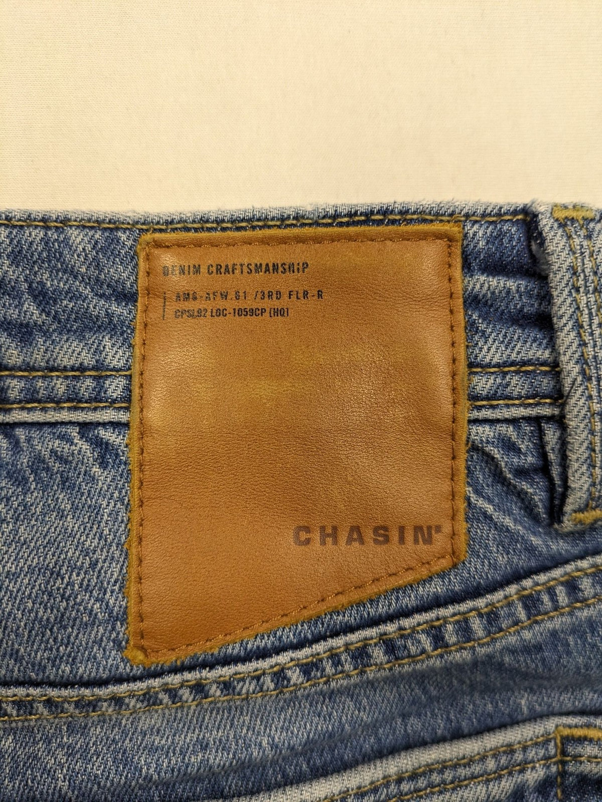 CHASIN' blue slim fit jeans with button fly and classic denim craftsmanship.