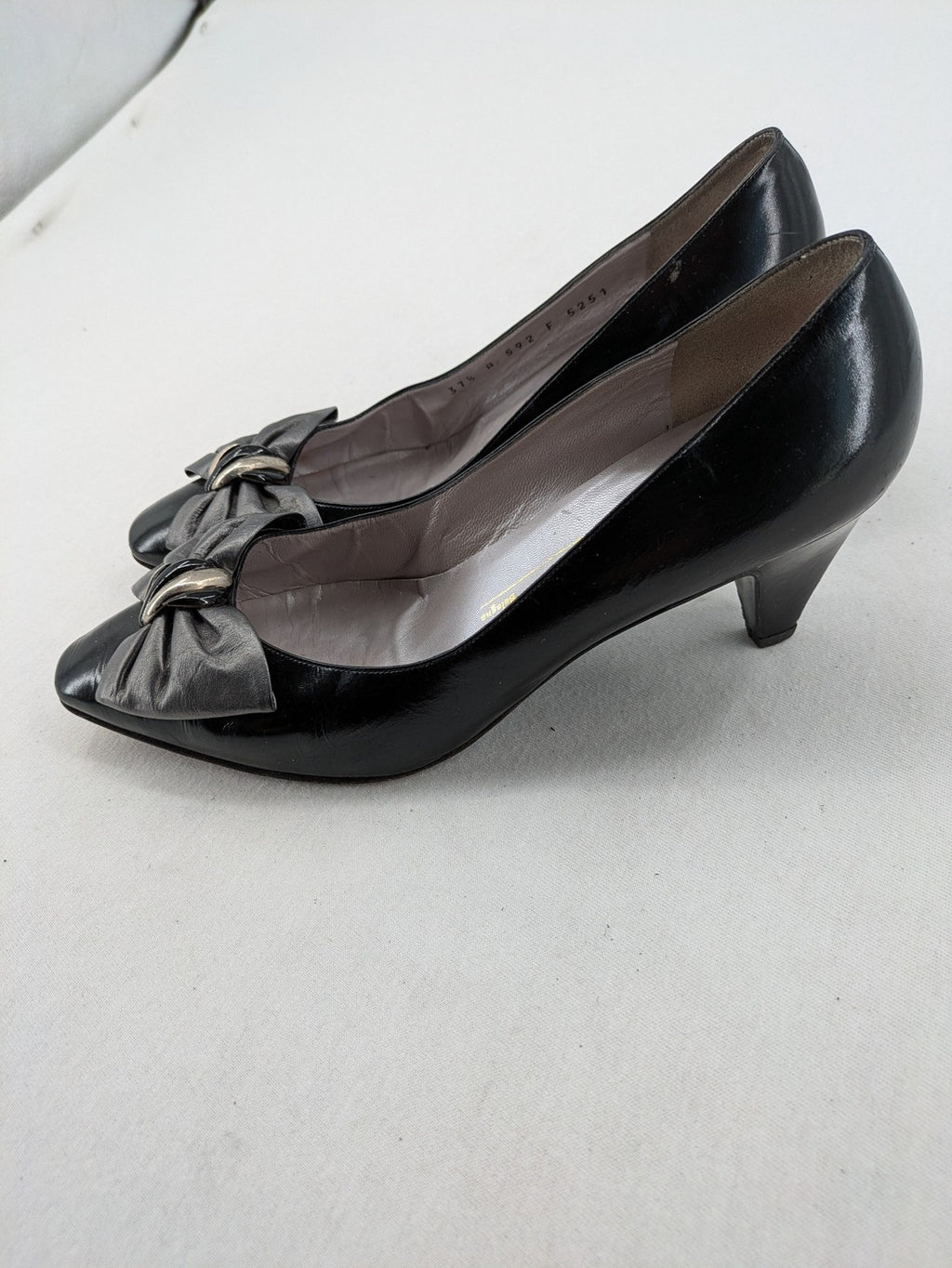 Bruno Magli black high heels leather with grey bow detail and classic silhouette.