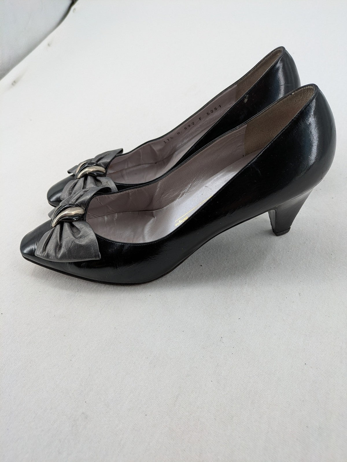 Bruno Magli black high heels leather with grey bow detail and classic silhouette.
