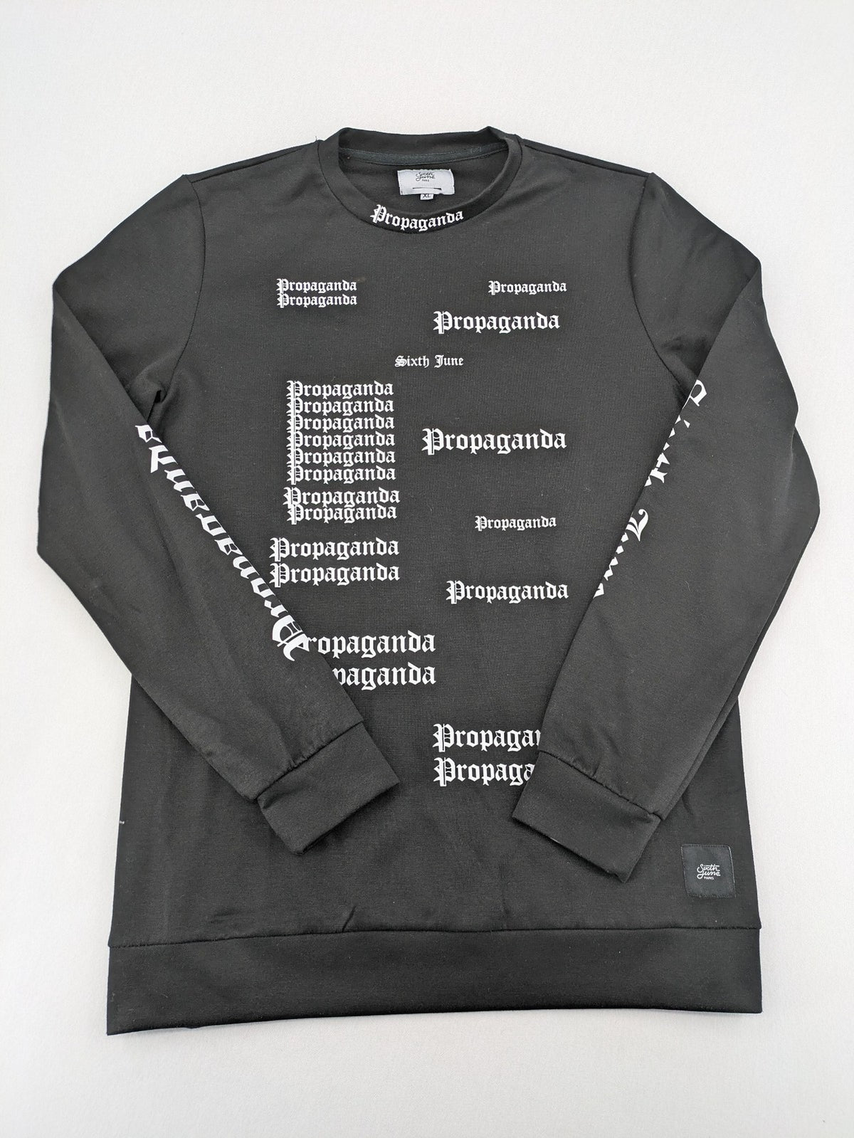 Sixth June black sweatshirt with Gothic "Propaganda" graphic print and logo details.