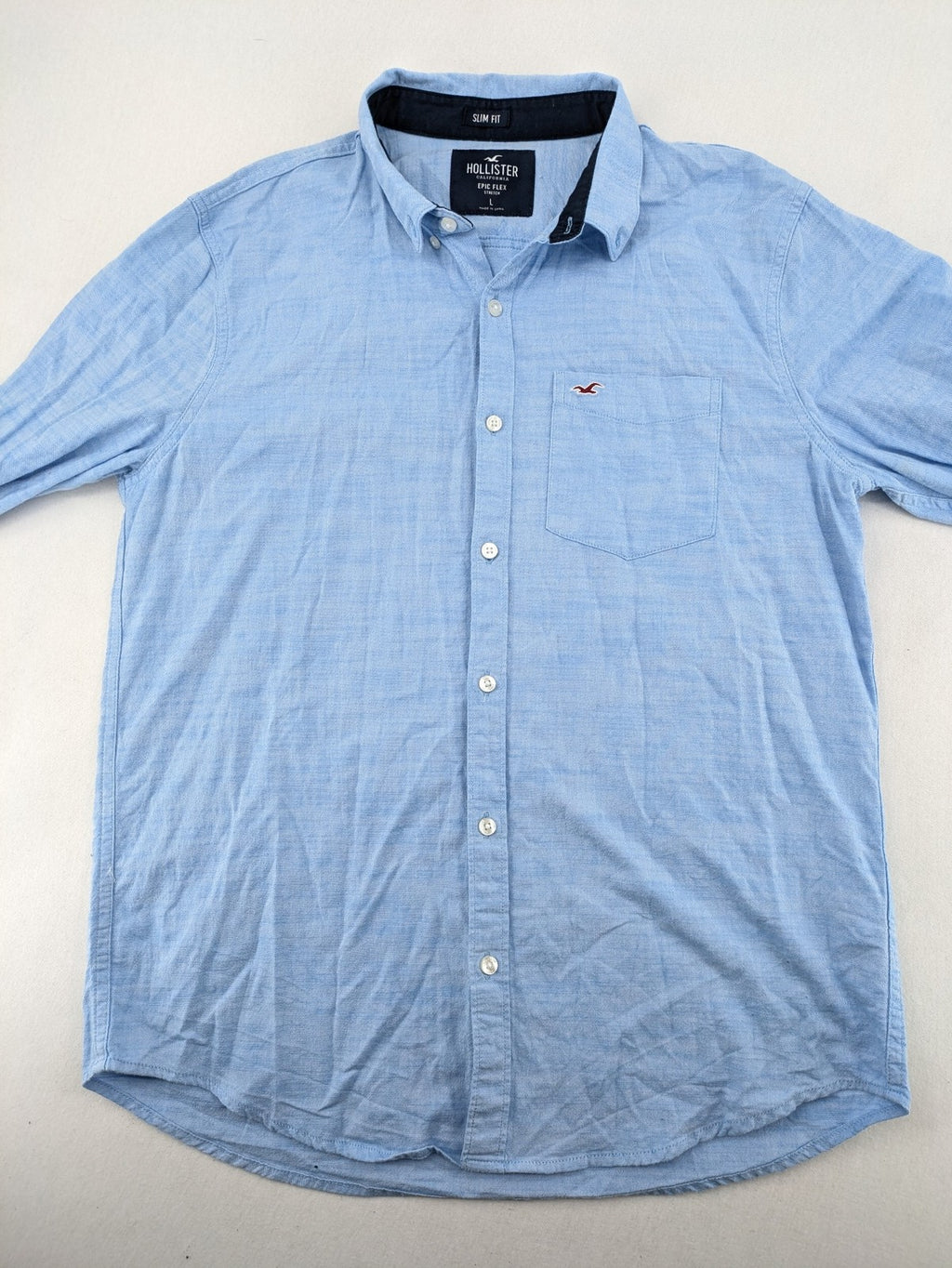 Hollister blue button-down shirt slim fit with embroidered logo and chest pocket.