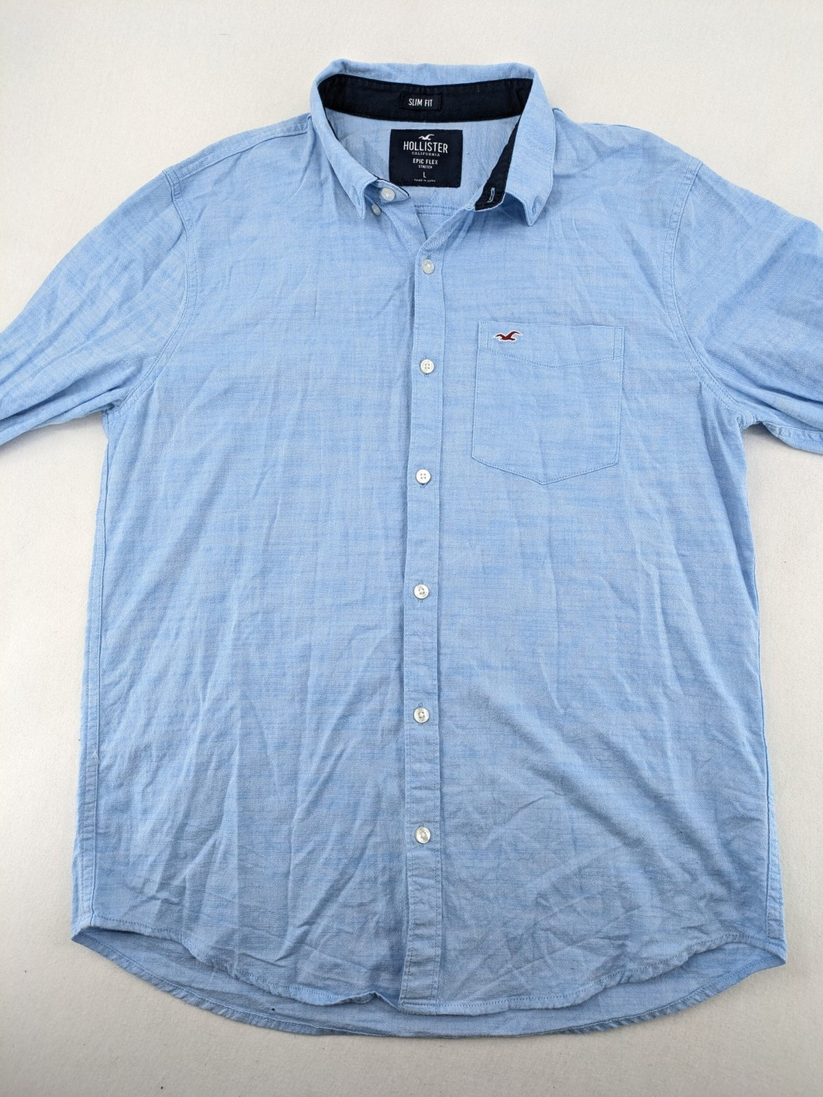 Hollister blue button-down shirt slim fit with embroidered logo and chest pocket.