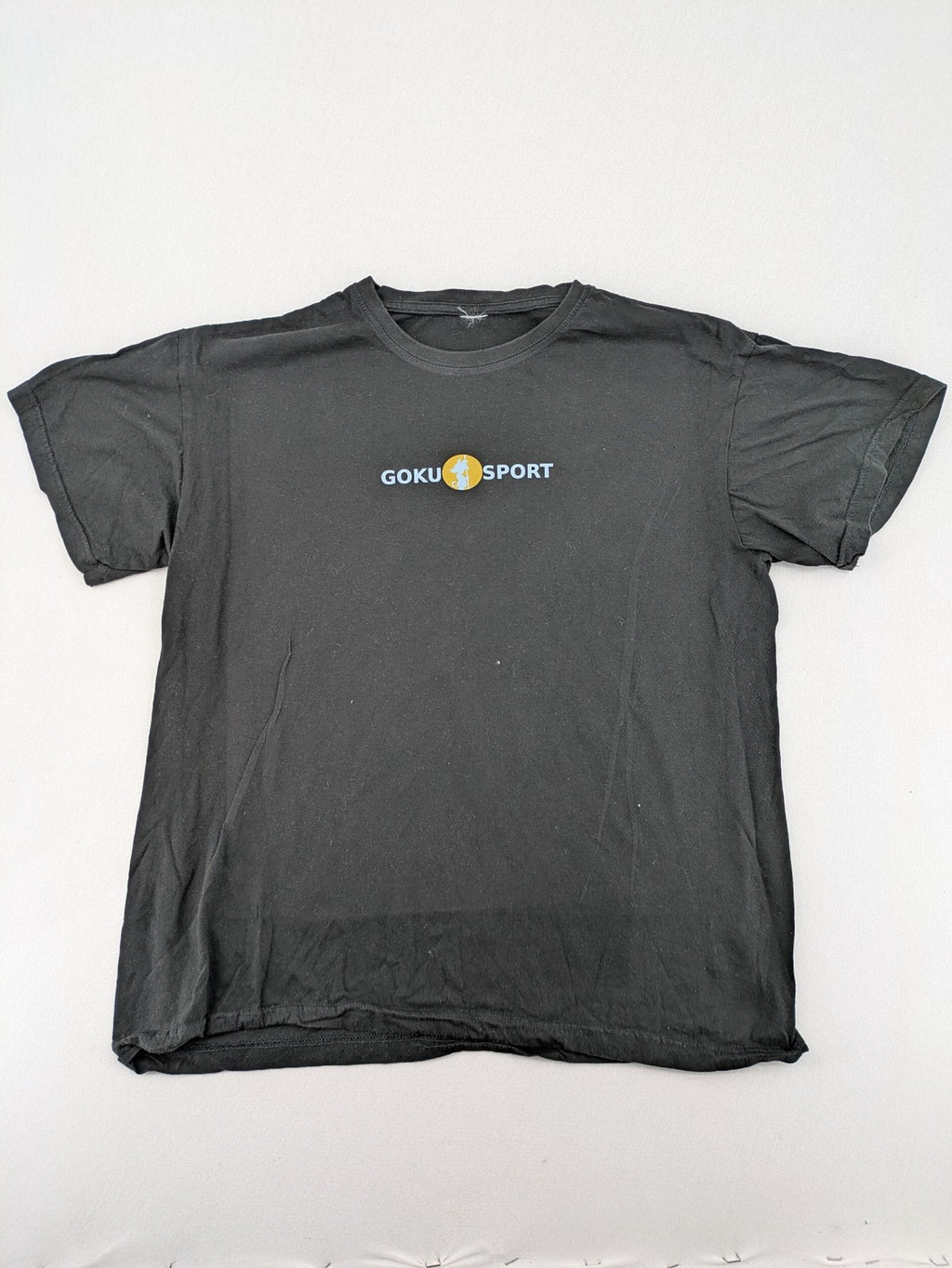Dragon Ball Z black t-shirt featuring Goku Sport logo and silhouette on Flying Nimbus.