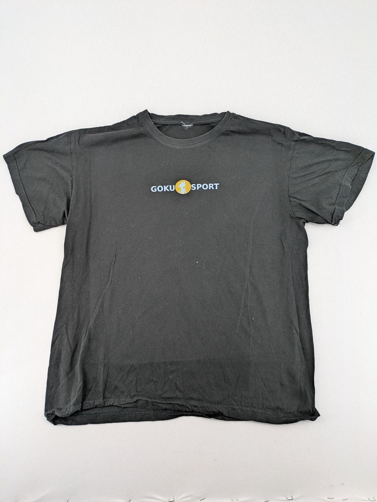Dragon Ball Z black t-shirt featuring Goku Sport logo and silhouette on Flying Nimbus.
