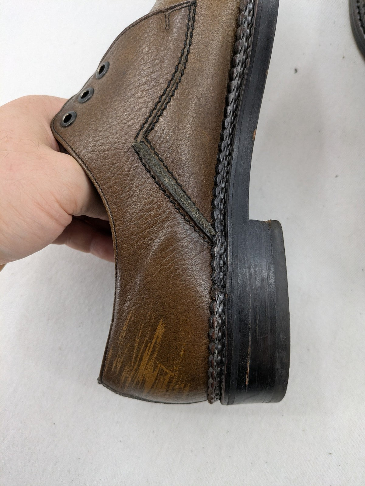 Fonda brown deck shoes genuine leather square toe design with decorative stitching.