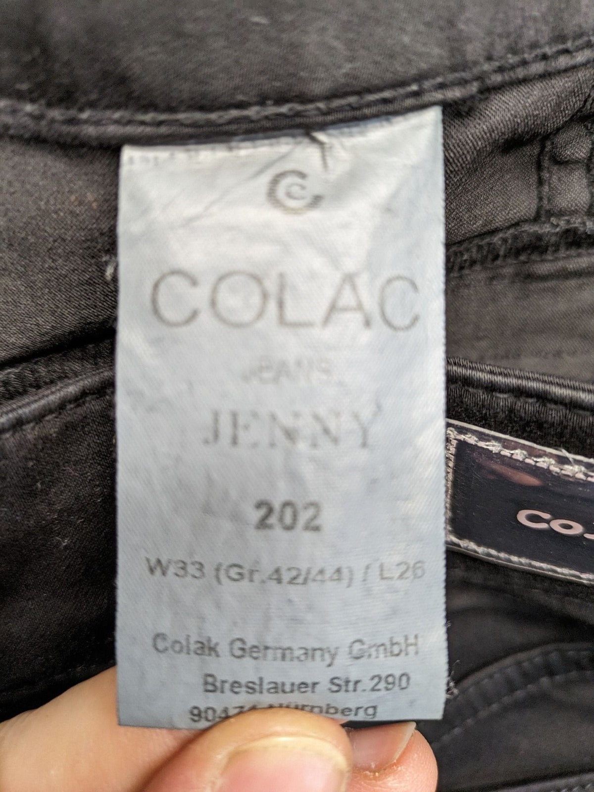 Colac black straight jeans high waist with double button, zipper pockets, and stretch material.
