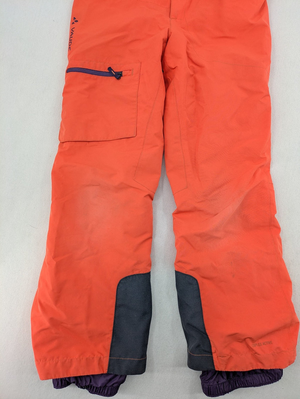 Vaude orange ski pants with logo, Primaloft insulation, and Ceplex Active membrane.