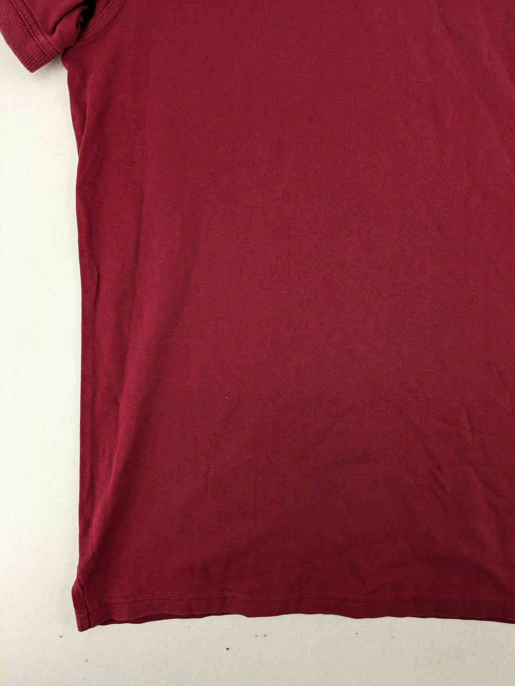 GANT burgundy polo shirt with embroidered shield logo and contrasting navy collar details.