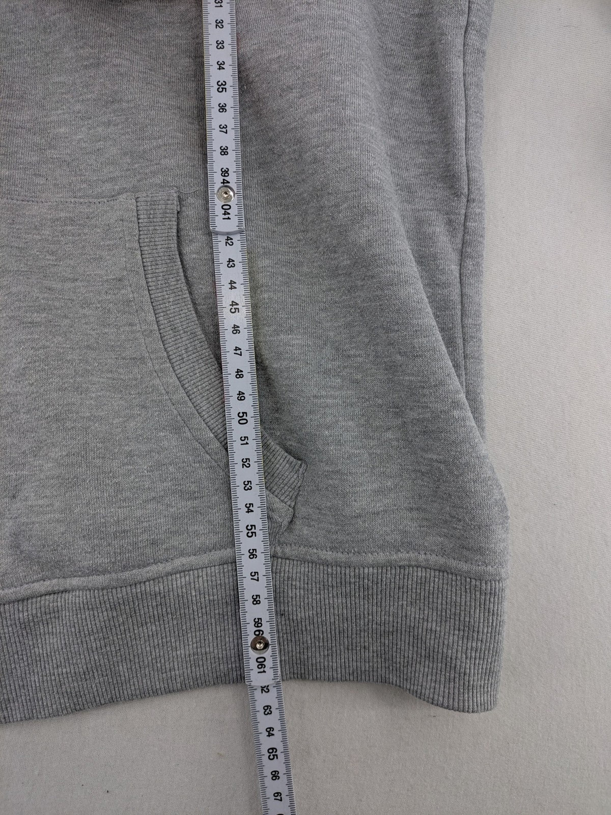 Primark grey zip-through hoodie featuring yellow Smiley logo and Nevermind graphic.